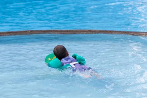 Little boy practicing swimming in the pool. Stock Photos