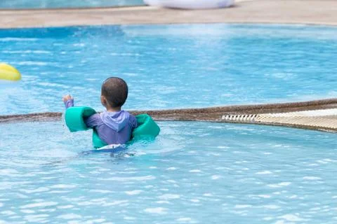 Little boy practicing swimming in the pool. Stock Photos