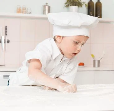 Little boy preparing dough Stock Photos