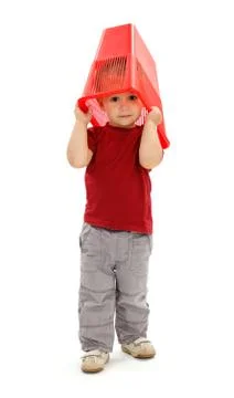 Little boy pulling garbage bin on head Stock Photos