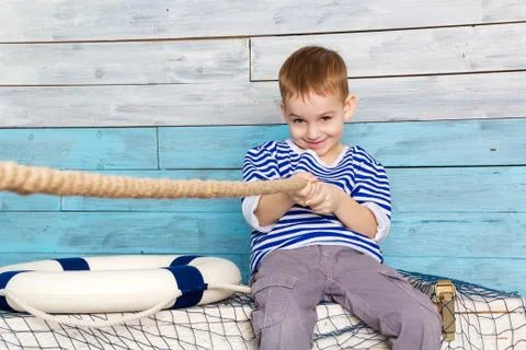Little boy pulling a rope Stock Photos