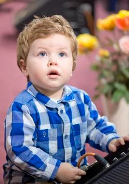 Little boy putting a cable into a speaker Stock Photos