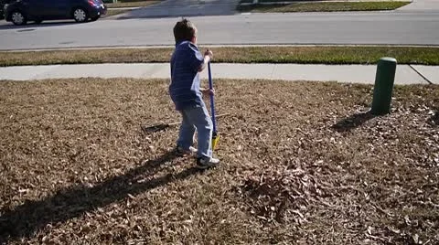 Little Boy Raking Stock Footage 10722468