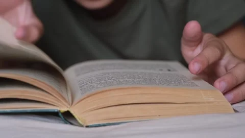 Little boy read a book in a bed. Video stock 252447367