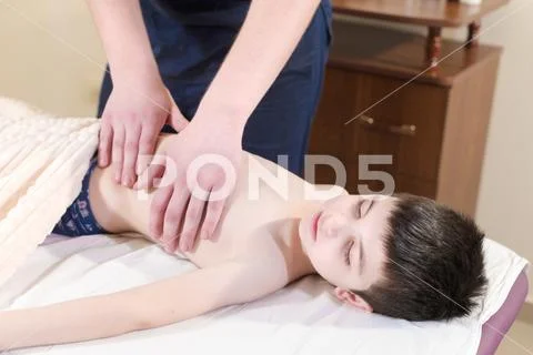 A little boy at the reception at a professional masseuse. Male manual worker Stock Photos