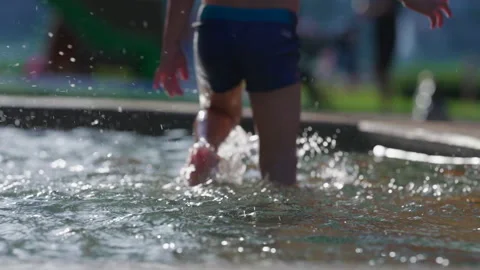 Little boy refreshing himself at public swimming pool during summer day act.. Stock Footage 247486638