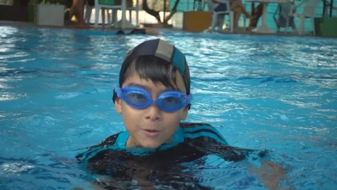 Little boy relaxing training lesson in swimming pool summer time Stockbeeldmateriaal 74618042