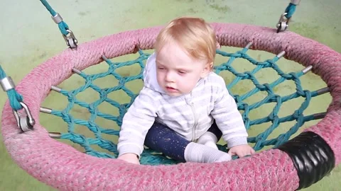 A little boy rides on a hammock Stock Footage 134256593