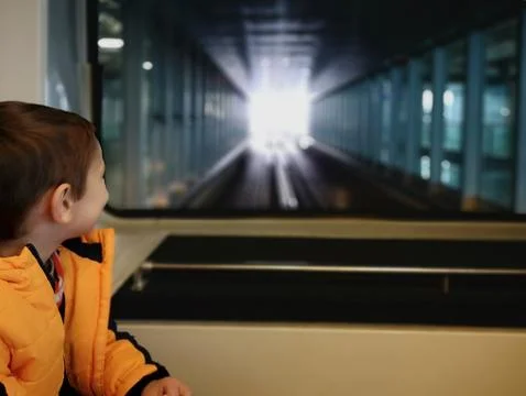 Little boy rides a train between terminals at Frankfurt am Main airport,Germany Stock Photos