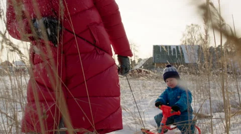 Little Boy Riding the Sledge in Winter Day Stock Footage 60387229