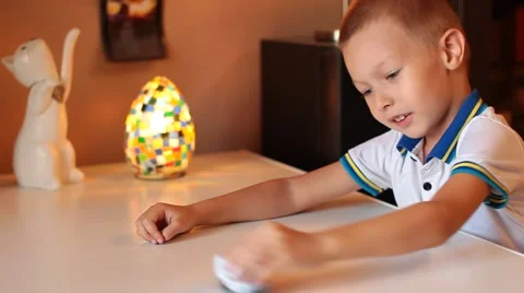 The little boy rolls a machine on the table Stock Footage 56169764