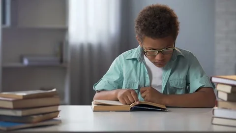 Little boy rubbing tired from active reading eyes, doing lots of homework Stock Footage 80688652