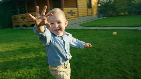 Little boy running and having fun on the backyard at sunset Stock Footage 75178881