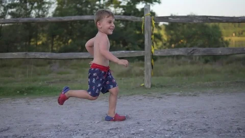 Little boy running in the park Stock Footage 79961633