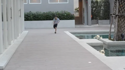 Little boy running on sidewalk Stockbeeldmateriaal 45636672
