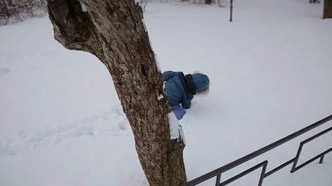 Little boy running through the snow slow motion Stock Footage 73356154
