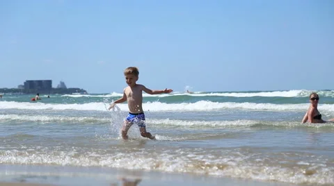 Little boy running through the waves Stock Footage 52822297