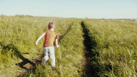 A little boy runs along the path. Stock Footage 79103591