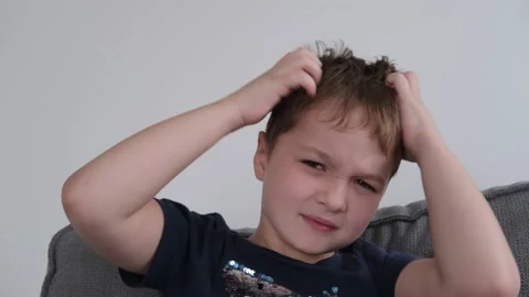 Little boy scratching his head, allergies, lice Stock Footage 166348407