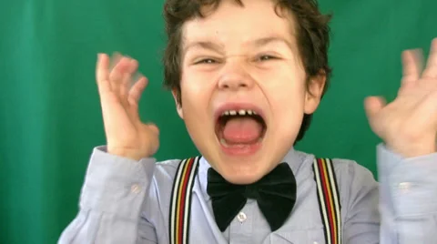 Little boy screaming in front of a green screen 2 Stock Footage 35296172