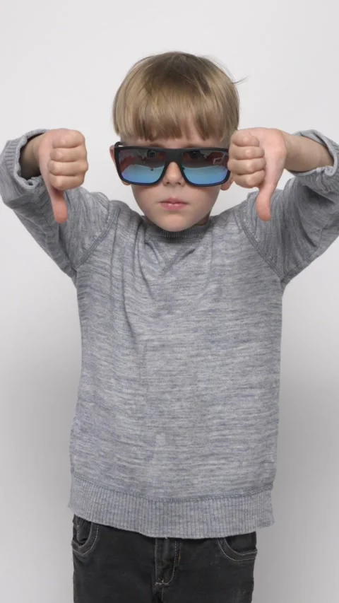 A little boy is showing thumb down. Dislike Gesture. Stock Footage 282307076