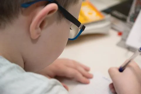 Little boy sits at a table Stock Photos