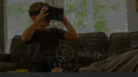 Little boy sitting on a couch wearing a virtual reality headset Stock Footage 108636948