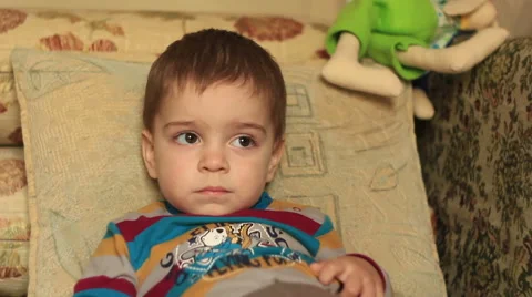 A little boy sitting on the sofa, front view Stock Footage 45616341