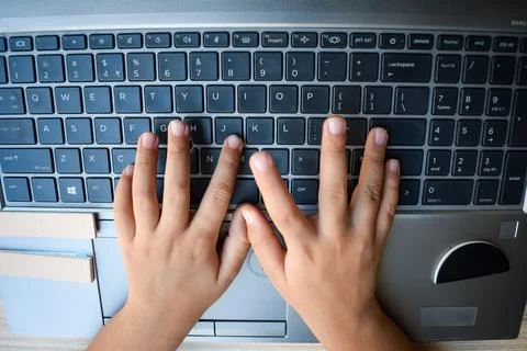Little boy sitting at table using laptop for online class in Grade 1, Child.. Foto stock