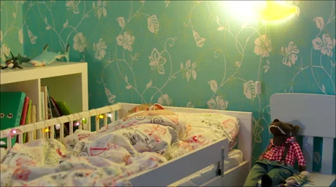 Little boy sleeping and turning off bedside lamp Stock Footage 62732079
