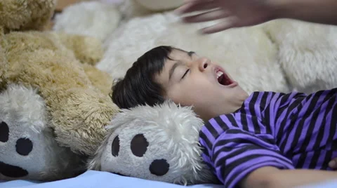 Little boy sleeping in bed on big bear doll Stockbeeldmateriaal 51239607