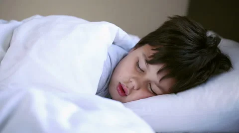 Little boy sleeping in bed, close up Stock Footage 46317289