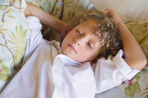 Little boy sleeping on couch Stock Photos