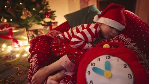 Little boy sleeping on New Years night Stock Footage 73028541