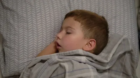 Little Boy Sleeping Peacefully in Bed Under Blanket Stock-Footage 343894622