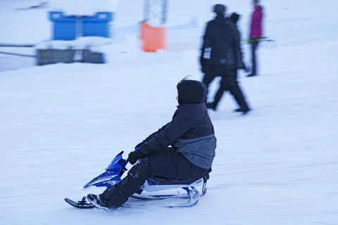 A little boy slides down the ski slope Stock Photos