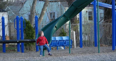 Little boy sliding down a slide, long shot Stock Footage 50067131