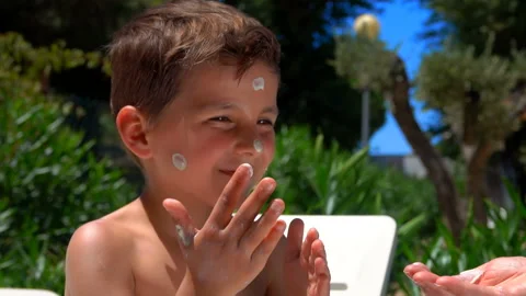 Little boy smeared with sunscreen Stock Footage 113054819