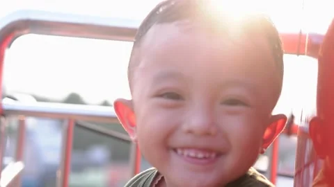 Little boy smiling to camera in the sunset at evening time. 스톡 동영상 157590988