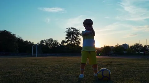 Little boy soccer player doing exercise before training at sunset Stock Footage 197742140