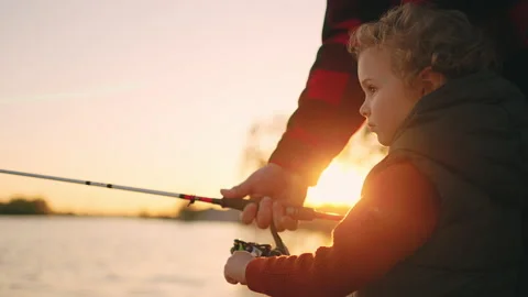 Little boy is spending weekend with dad or grandpa in nature, child is fishing Stock Footage 201002032