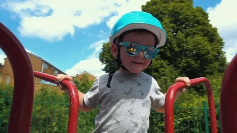 Little Boy spinning on the carousel Stock Footage 79976285