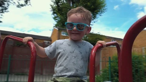 Little Boy spinning on the carousel Stock Footage 79976317