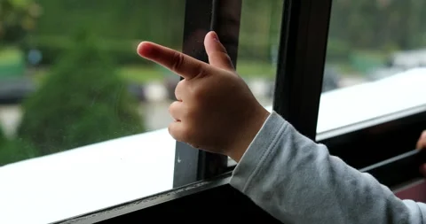 Little boy standing by window pointing o... | Stock Video | Pond5