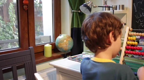 Little boy, student, schoolboy using abacus, learning, counting, homework Stock Footage 43115779