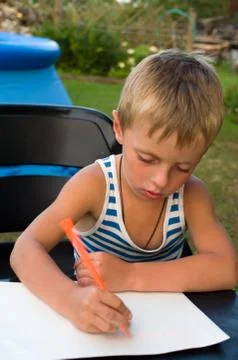 The little boy studies to write Stock Photos