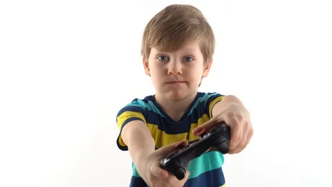 Little boy in the studio on a white background plays the joystick in video games Stock Footage 124227760