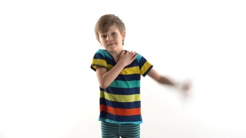 Little boy in the studio on a white background dancing funny dance Stock Footage 124229063