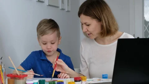 Little boy study online drawing with his mother via internet looking at laptop Stock Footage 128433643
