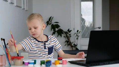 Little boy study online drawing via internet looking at laptop, distant Stock Footage 129082473